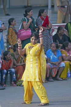 Indian woman dancing in the street as part of the ceremony closing the border between India and Pakistan at Wagah, Punjab, India