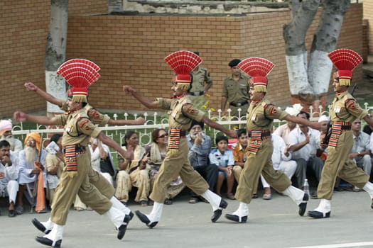 Indian soldiers in dress uniform marching as part of the ceremony closing the border between India and Pakistan at Wagah, Punjab, India