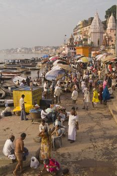 Crowds of people worshiping bathing in the sacred River Ganges at Varanasi, India