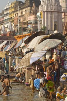 Crowds of people bathing in the sacred River Ganges in the sacred city of Varanasi, Uttar Pradesh, India