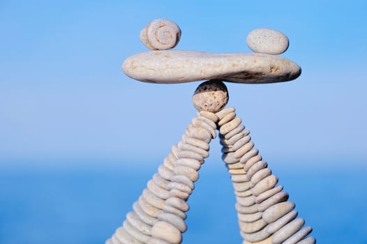 Balancing of white pebbles on the top of piles