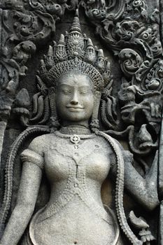 Rock sculpture of a smiling goddess at Angkor, Cambodia