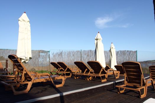 Sun chairs on the beach, summer holiday