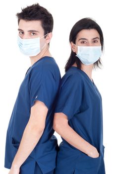 back to back portrait of a team of doctors wearing mask and uniform isolated on white background