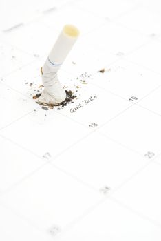 A reminder on a calendar of a smokers quit date to achieve a healthy goal.