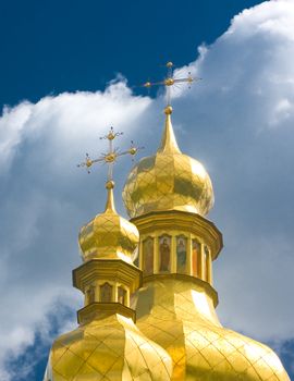 Ukraine, Golden Cupola of Orthodox church and blue sky with clouds