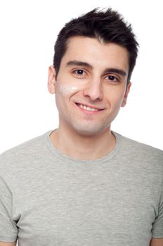 handsome young man with cream lotion on face (isolated on white background)