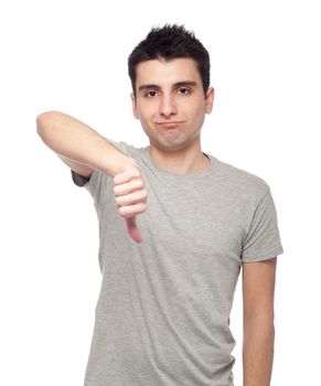 handsome young man with thumbs down on an isolated white background