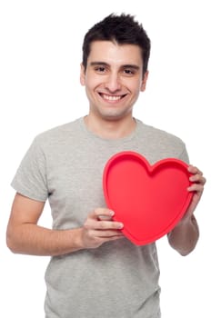lovely portrait of a young man holding a red heart (isolated on white background)