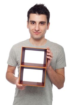happy young man holding empty frame isolated on white background