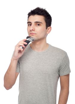 handsome young man shaving with electric shaver (isolated on white background)