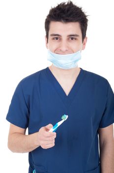 young male dentist with mask and toothbrush isolated on white background