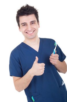 smiling male dentist holding toothbrush and showing thumb up isolated on white background