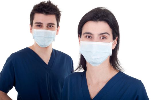portrait of a team of doctors, man and woman wearing mask and uniform isolated on white background (focus on woman)
