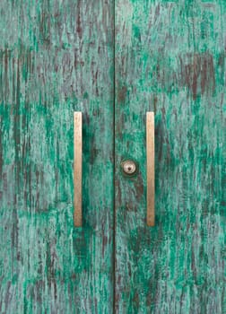 Wood green door with knob and keyhole