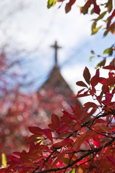 church or chapel through red autumn fall leaves