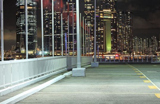 car park at night and modern buildings as background