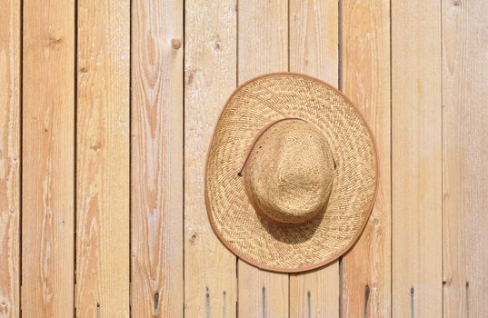 Yellow old-fashioned straw on a wooden timbered wall