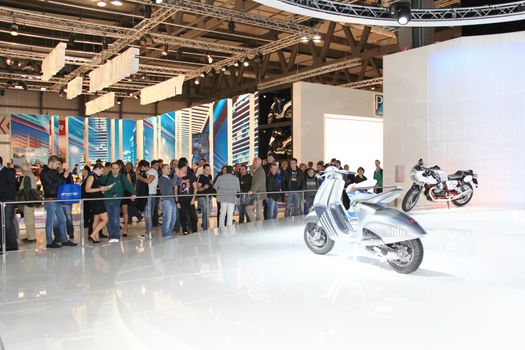 Visiting scooters and motorcycels stands during EICMA 2011, International Motorcycle Exhibition in Milan, Italy