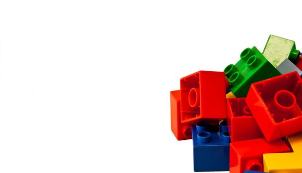Plastic building blocks on white background. Bright colors.