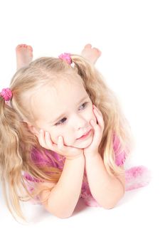 Little cute girl in pink and with ponytails in studio