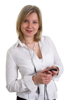 Smiling with earphones girl listening music, holding mp3 player in her hands. Isolated on white background.