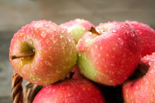 A close up of apples covered with rain drops.