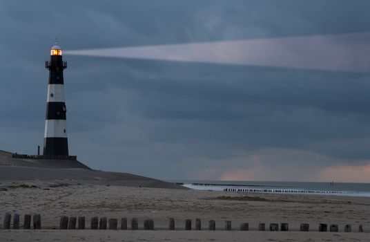 Vuurtoren Breskens lighthouse in the Netherlands shining in the night.