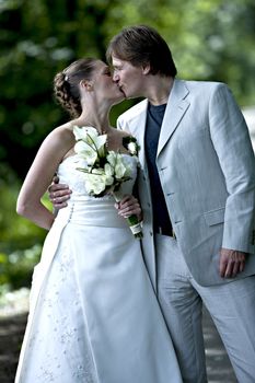 Wedding couple posing with a kiss