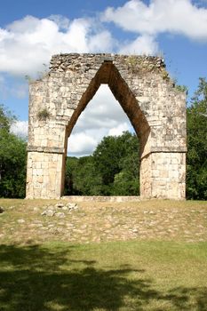 Big arch in mayan ruins over blue sky