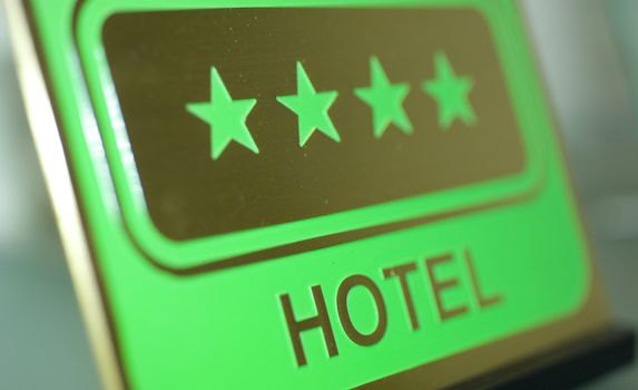 four star hotel sign green and gold