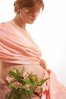 pregnancy woman in the rose colored drapery