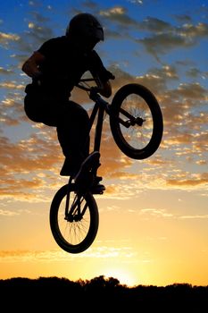 BMX bike high up in the air.
