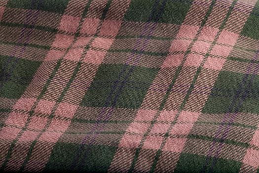 A folded flannel pattern of green and tan.