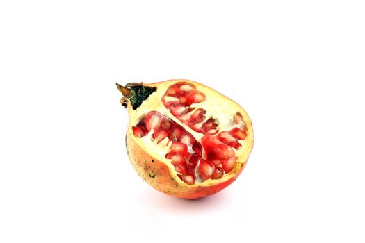 half of pomegranate on white bacjground