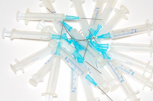 heap of used disposable syringes