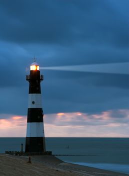 Vuurtoren Breskens lighthouse in the Netherlands shining in the night.