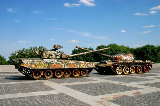two decorated tanks with crossed barrels