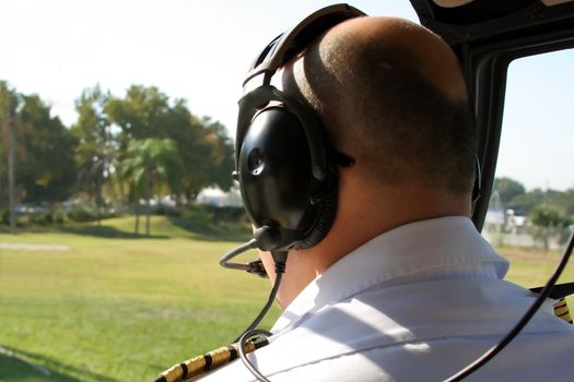 pilot in cockpit of helicopter