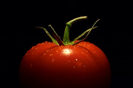 half the tomato on black background