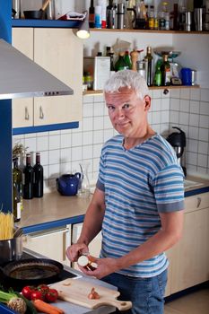 handsome man cooking pasta in the kitchen