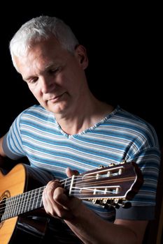 handsome man playing classical guitar