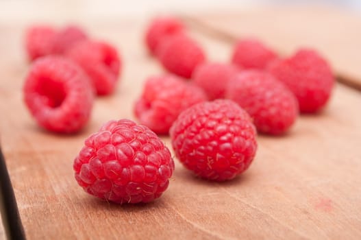 Fresh Red Raspberries on Old Wooden Table