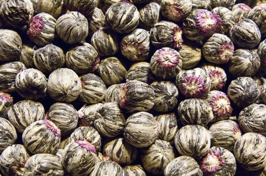 A pile of blooming flower tea balls ready to be used. These bloom and flower when immersed in hot water giving a delicate aroma and a wonderful herbal infusion to your tea.