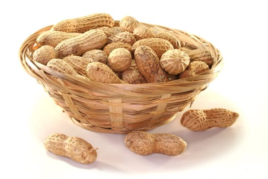 Peanuts in a basket on a white background