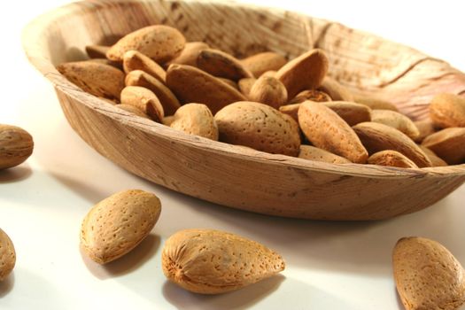 Almonds in a bowl on a white background