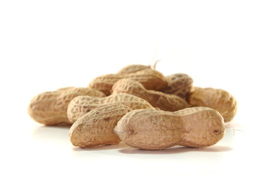 Peanuts in a pile on a white background