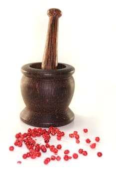 Mortar with red pepper on a white background