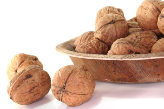 Walnuts in a bowl on a white background