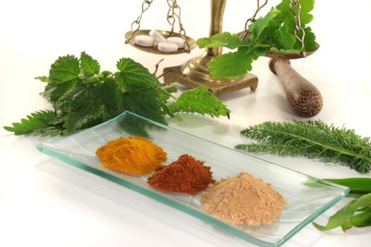 Pharmacists scale with mortar, tablets and fresh herbs